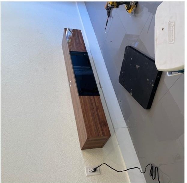 Wall-mounted residential furniture installation in progress