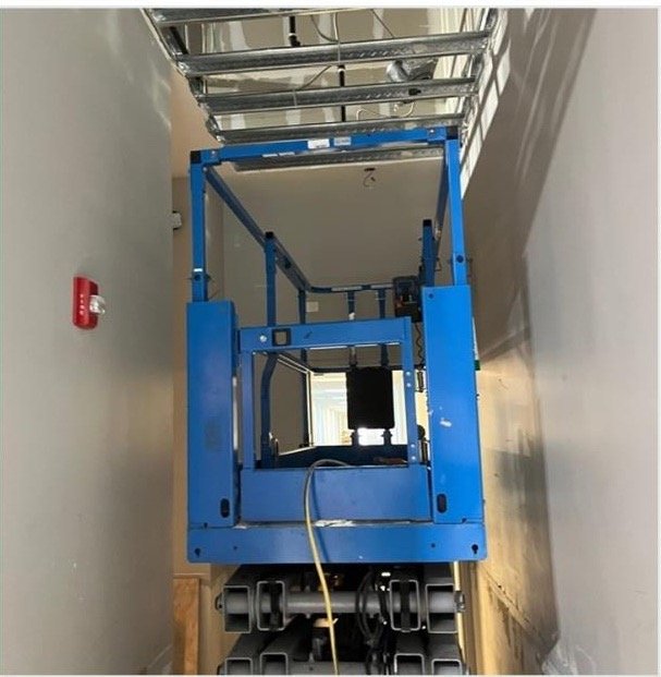Technician working from a scissor lift
